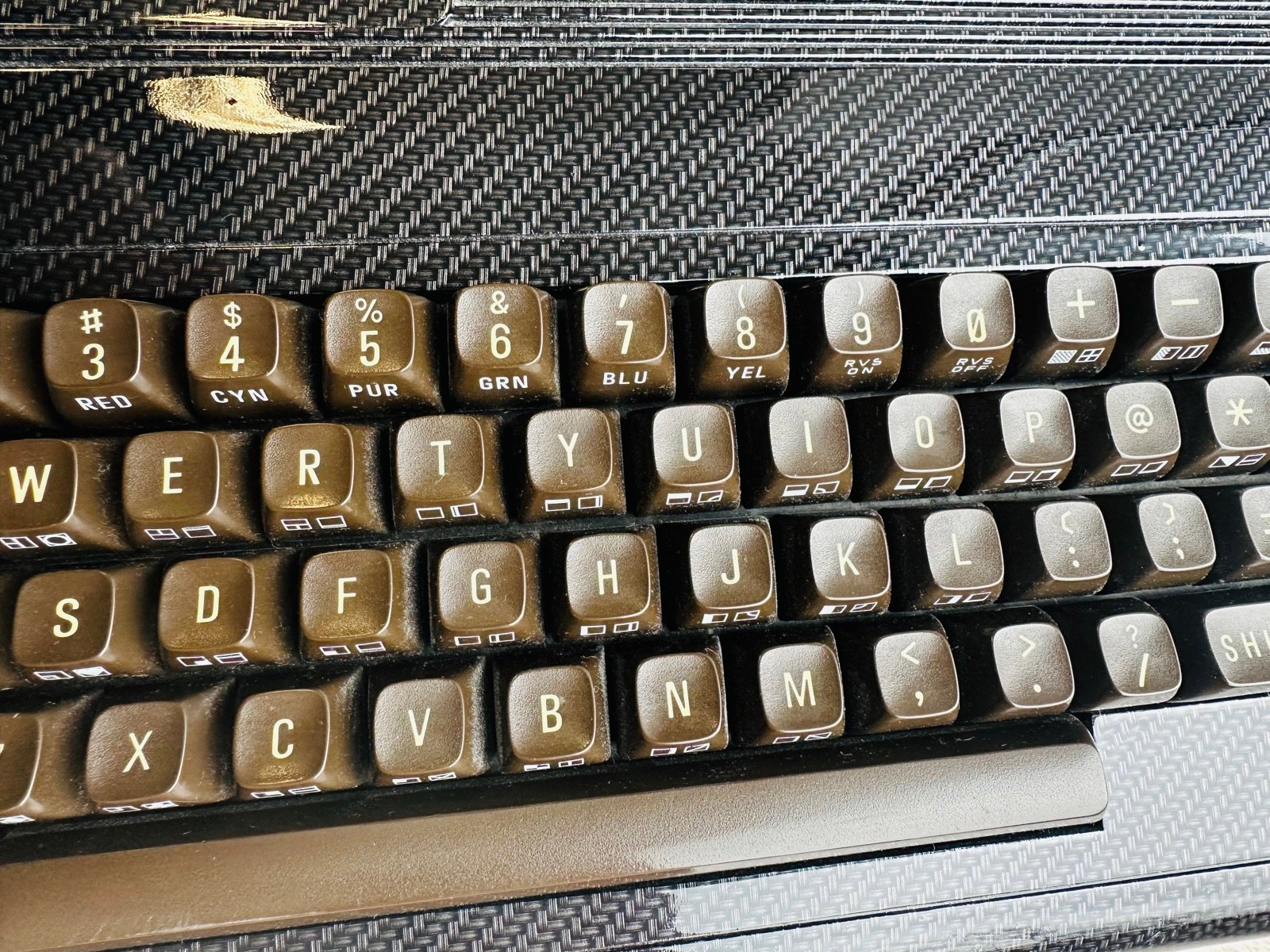 Makro fotografia klawiatury Commodore 64 z widocznymi opisami funkcji kolorów